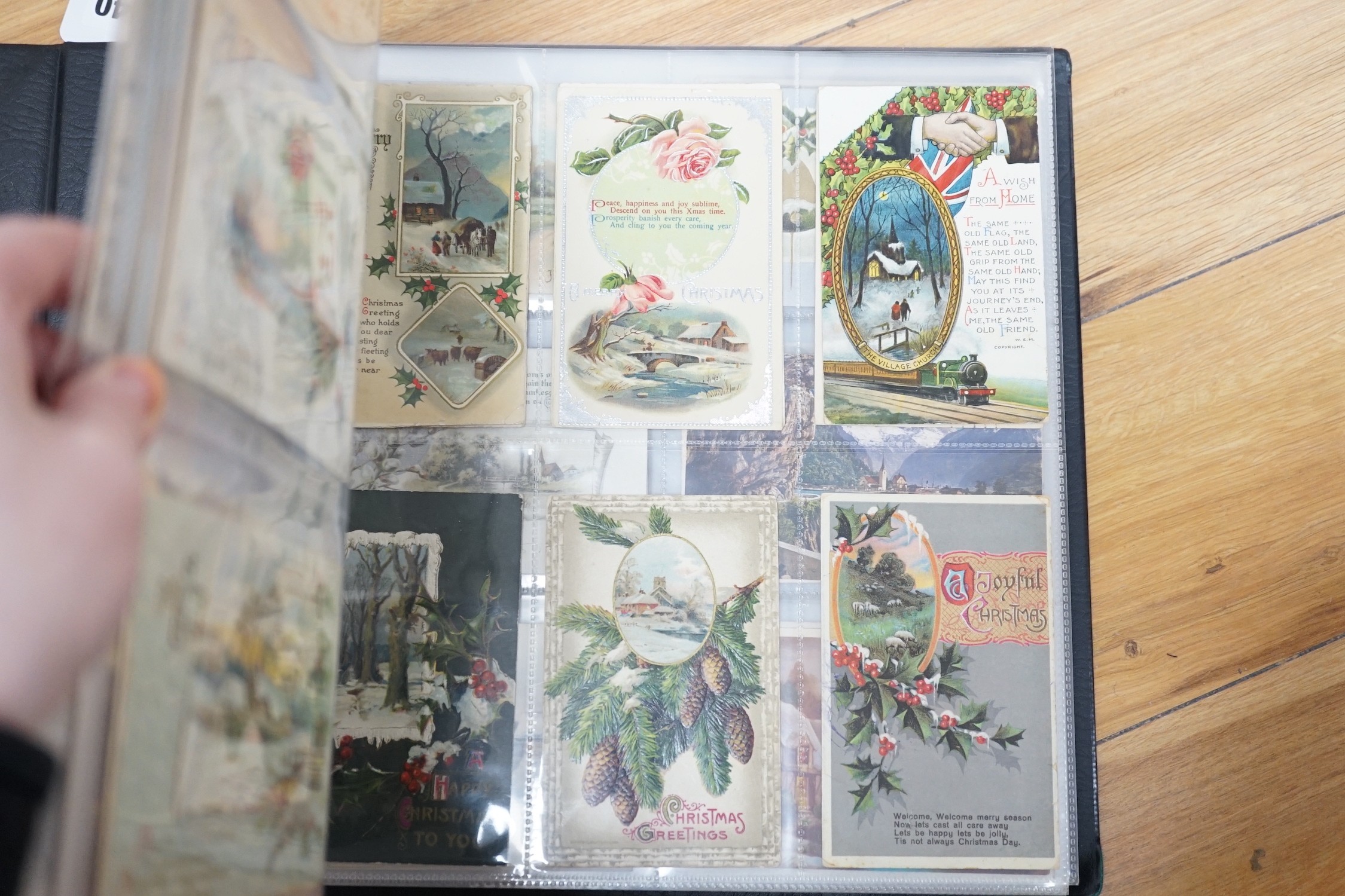 A selection of early 20th century postcards in an album, to include novelty, Christmas, Happy New Year, German, French, Paris, English locations, including Brighton, etc.